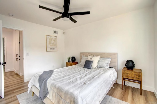 bedroom with light wood-type flooring and ceiling fan