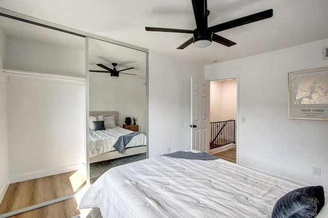 bedroom with ceiling fan, a closet, and hardwood / wood-style floors