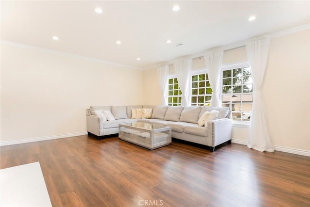 living room featuring dark hardwood / wood-style floors and ornamental molding