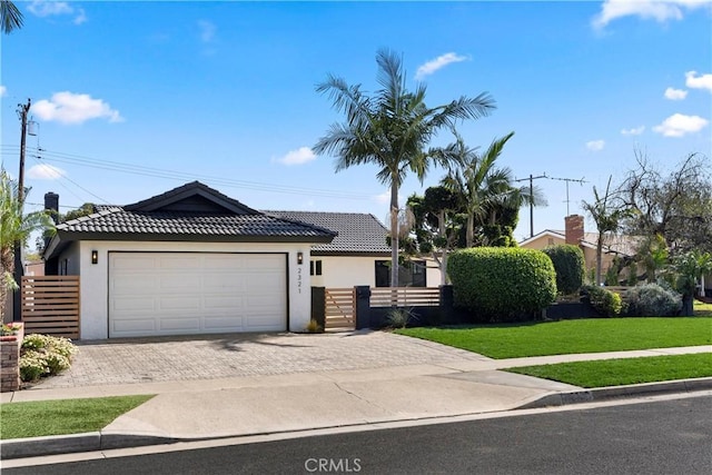 view of front of house with a front lawn and a garage