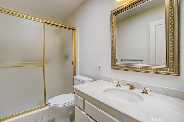 full bathroom with vanity, a shower stall, and toilet