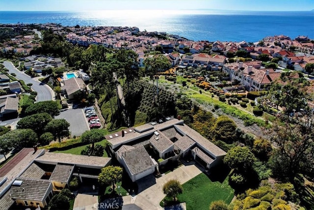 drone / aerial view with a water view and a residential view