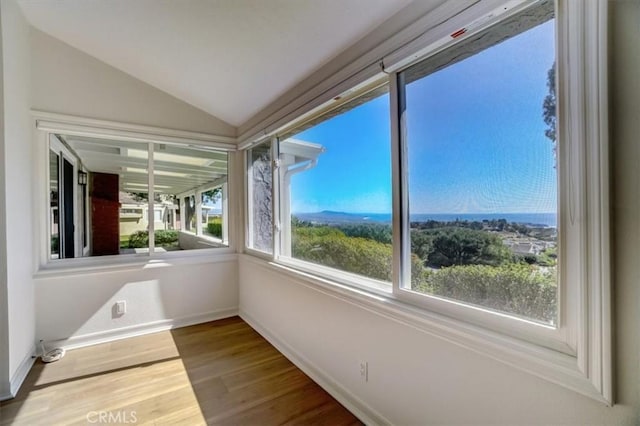 unfurnished sunroom featuring lofted ceiling