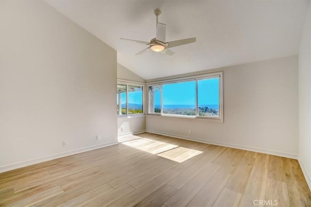 spare room with light wood-style floors, baseboards, and a ceiling fan