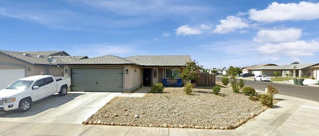 ranch-style house featuring concrete driveway, an attached garage, and stucco siding