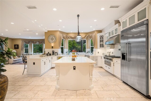 27 Round Up Rd, Bell Canyon, CA 91307 - kitchen featuring built in fridge, stone tile floors, exhaust hood, a breakfast bar area, and recessed lighting
