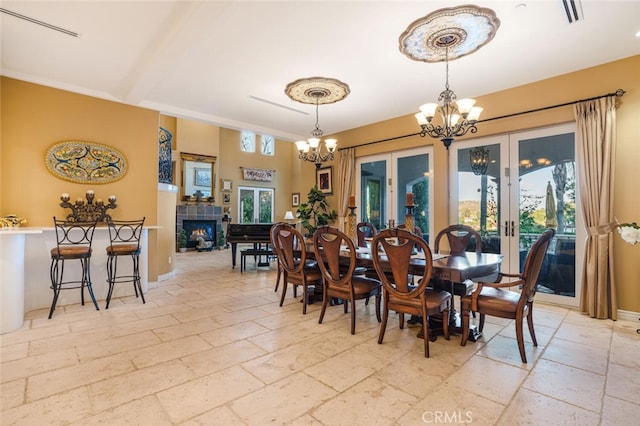 27 Round Up Rd, Bell Canyon, CA 91307 - dining space with a chandelier, stone tile floors, french doors, and a tile fireplace