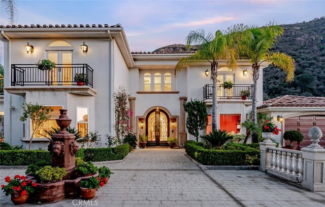 27 Round Up Rd, Bell Canyon, CA 91307 - mediterranean / spanish-style home featuring a balcony, french doors, and stucco siding