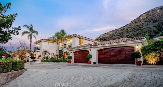 27 Round Up Rd, Bell Canyon, CA 91307 - mediterranean / spanish house with a garage, a mountain view, stucco siding, and decorative driveway