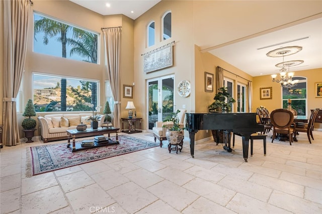 27 Round Up Rd, Bell Canyon, CA 91307 - living area featuring stone tile floors, a chandelier, healthy amount of natural light, and a towering ceiling
