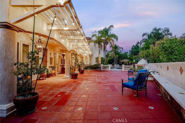 view of patio terrace at dusk