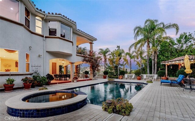 27 Round Up Rd, Bell Canyon, CA 91307 - pool at dusk featuring a patio area, a pool with connected hot tub, and a gazebo