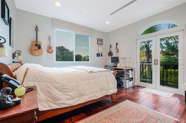 bedroom featuring dark hardwood / wood-style flooring, french doors, and access to exterior