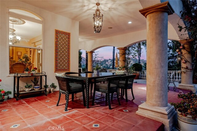 27 Round Up Rd, Bell Canyon, CA 91307 - tiled dining room featuring decorative columns, a chandelier, and arched walkways