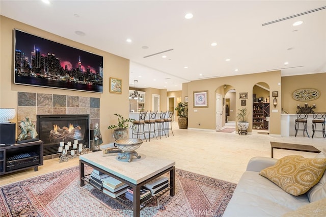 living room with a tiled fireplace