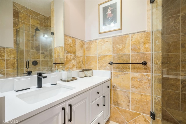 bathroom featuring tile walls, vanity, and an enclosed shower