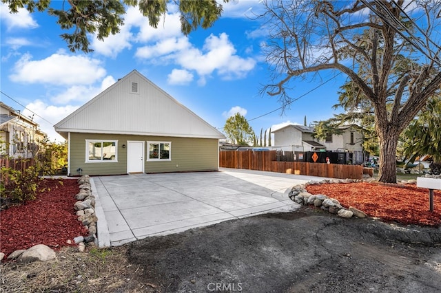 rear view of house with a patio area and fence