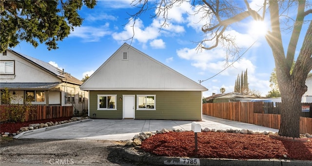 view of front of home with a patio and fence