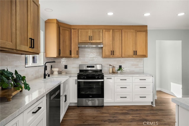 kitchen featuring stainless steel range with gas stovetop, white cabinetry, light stone countertops, dishwasher, and under cabinet range hood