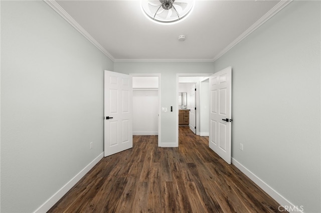 unfurnished bedroom featuring ornamental molding, dark wood finished floors, and baseboards