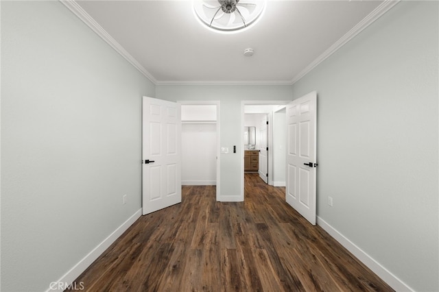 unfurnished bedroom featuring crown molding, baseboards, and dark wood-type flooring