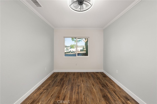 unfurnished room featuring baseboards, visible vents, ornamental molding, and dark wood finished floors
