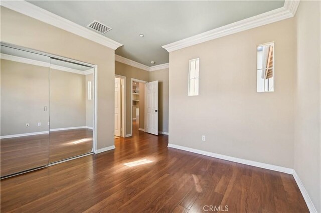 33 Perennial, Irvine, CA 92603 - unfurnished bedroom featuring wood finished floors, baseboards, crown molding, and a closet