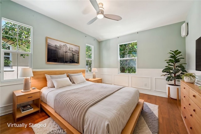 33 Perennial, Irvine, CA 92603 - bedroom featuring wainscoting, a wall mounted air conditioner, wood finished floors, vaulted ceiling, and ceiling fan