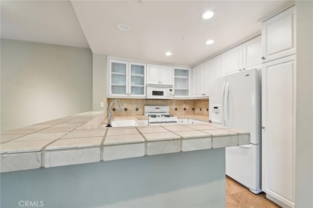 33 Perennial, Irvine, CA 92603 - kitchen featuring white appliances, a sink, white cabinetry, recessed lighting, and tile counters