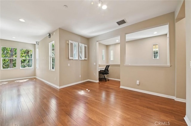 33 Perennial, Irvine, CA 92603 - unfurnished room with a desk, baseboards, and wood finished floors