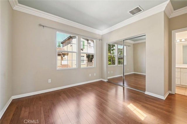 33 Perennial, Irvine, CA 92603 - unfurnished bedroom featuring ornamental molding, hardwood / wood-style floors, baseboards, a closet, and connected bathroom