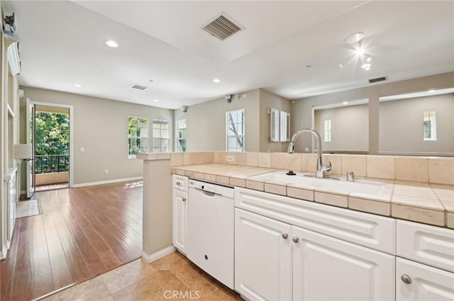 33 Perennial, Irvine, CA 92603 - kitchen with white dishwasher, tile counters, a sink, recessed lighting, and white cabinets