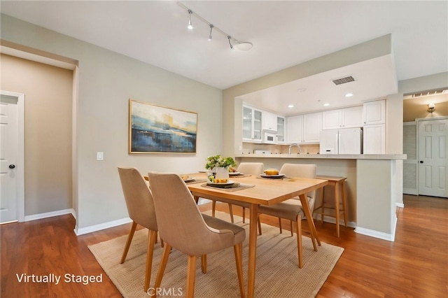 33 Perennial, Irvine, CA 92603 - dining room with track lighting, wood finished floors, and baseboards