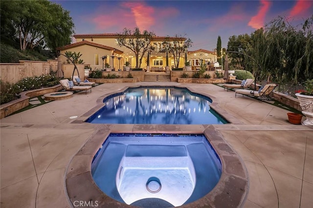 view of swimming pool featuring a fenced in pool, a patio area, fence, and an in ground hot tub