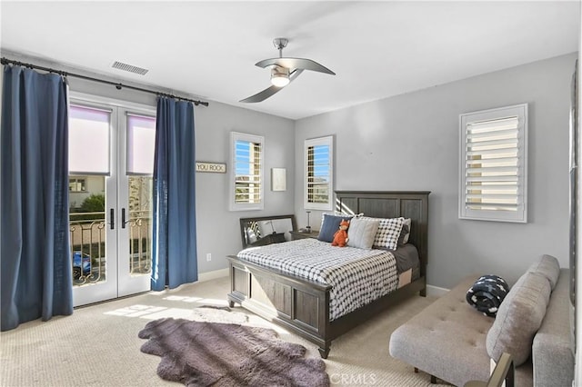 bedroom with ceiling fan, access to outside, french doors, and light colored carpet