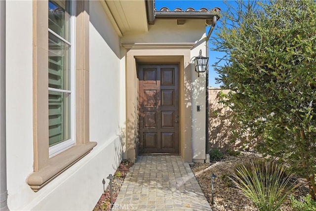 property entrance featuring stucco siding