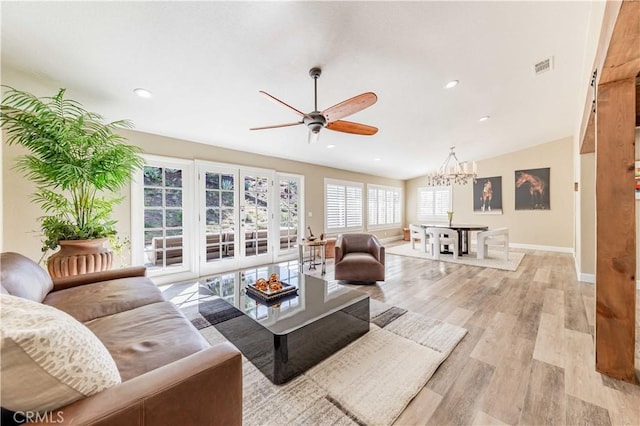 living room with light wood finished floors, recessed lighting, visible vents, baseboards, and ceiling fan with notable chandelier