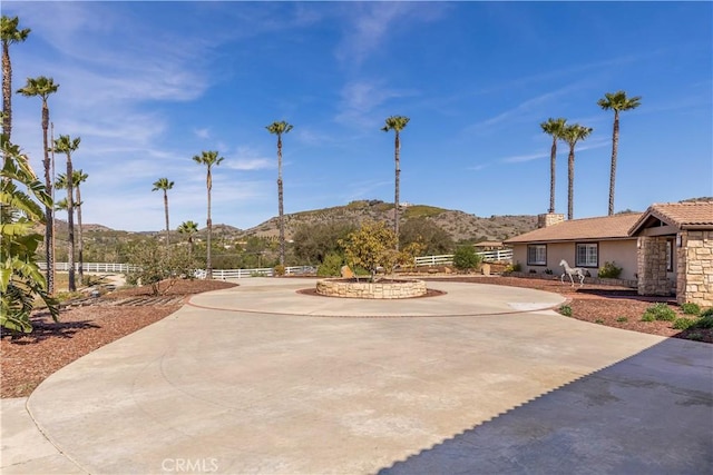 view of community featuring a mountain view and fence