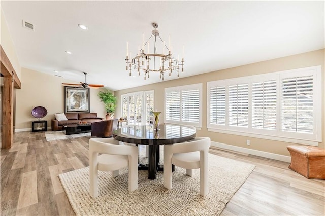 dining space with recessed lighting, visible vents, light wood-type flooring, baseboards, and ceiling fan with notable chandelier