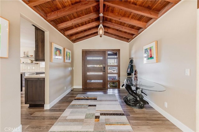 entrance foyer with wooden ceiling, lofted ceiling with beams, baseboards, and wood finished floors