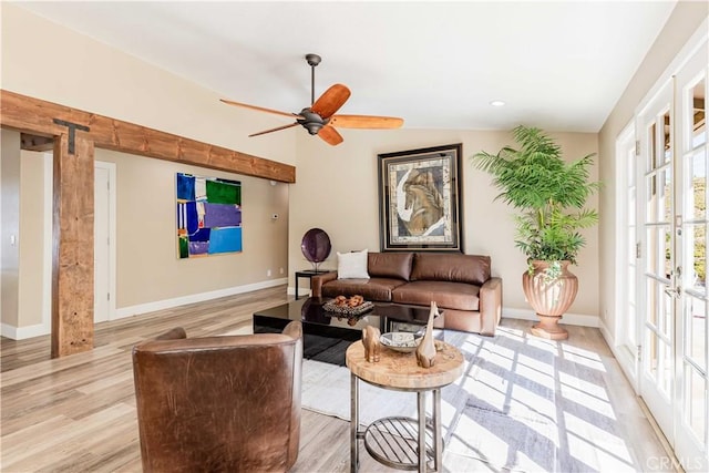 living area featuring a ceiling fan, recessed lighting, baseboards, and light wood finished floors