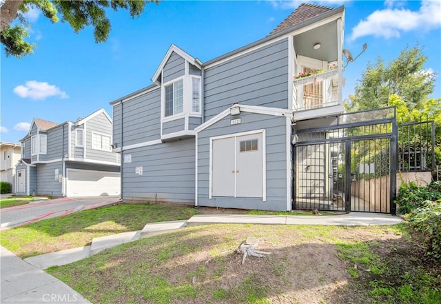 view of front of property with a front yard and a balcony