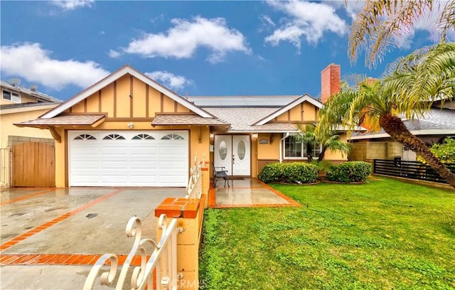 ranch-style house featuring aphalt driveway, a shingled roof, a front yard, roof mounted solar panels, and a garage