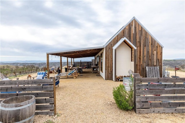 view of outbuilding featuring an outdoor structure, a mountain view, and an exterior structure