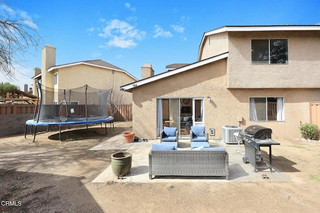 view of patio / terrace with a trampoline, outdoor lounge area, central air condition unit, and grilling area