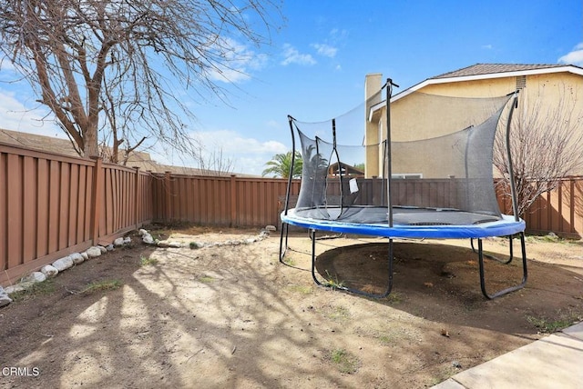 view of yard with a trampoline