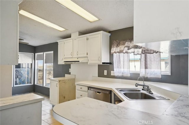 kitchen with dishwasher, light tile patterned floors, sink, white cabinetry, and kitchen peninsula