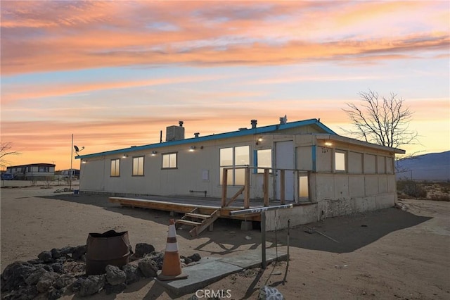 view of back house at dusk