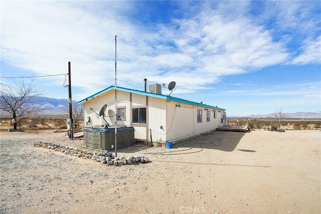 back of property featuring a mountain view