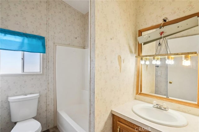 full bathroom featuring vanity, toilet, and washtub / shower combination